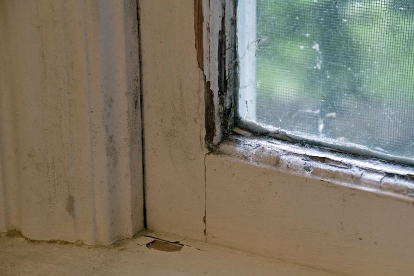 Rotted wood window frame on an old window
